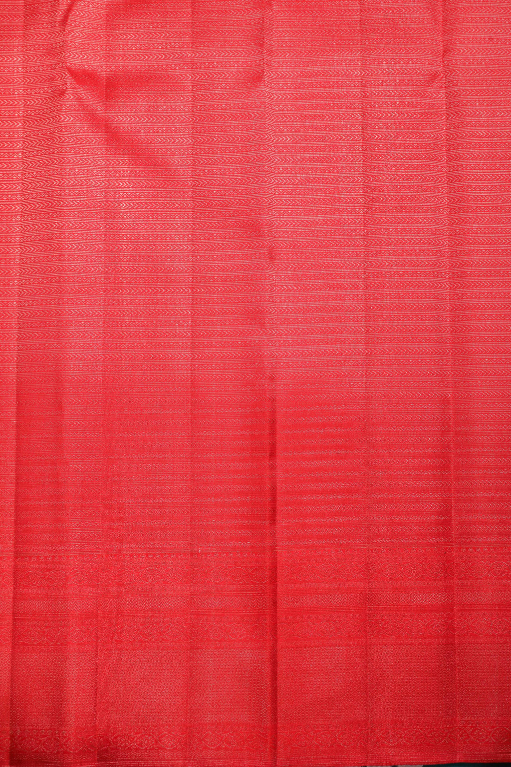 Red Kanchipuram silk saree with intricate zari patterns, perfect for bridal and festive occasions.