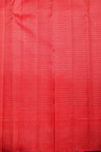 Red Kanchipuram silk saree with intricate zari patterns, perfect for bridal and festive occasions.
