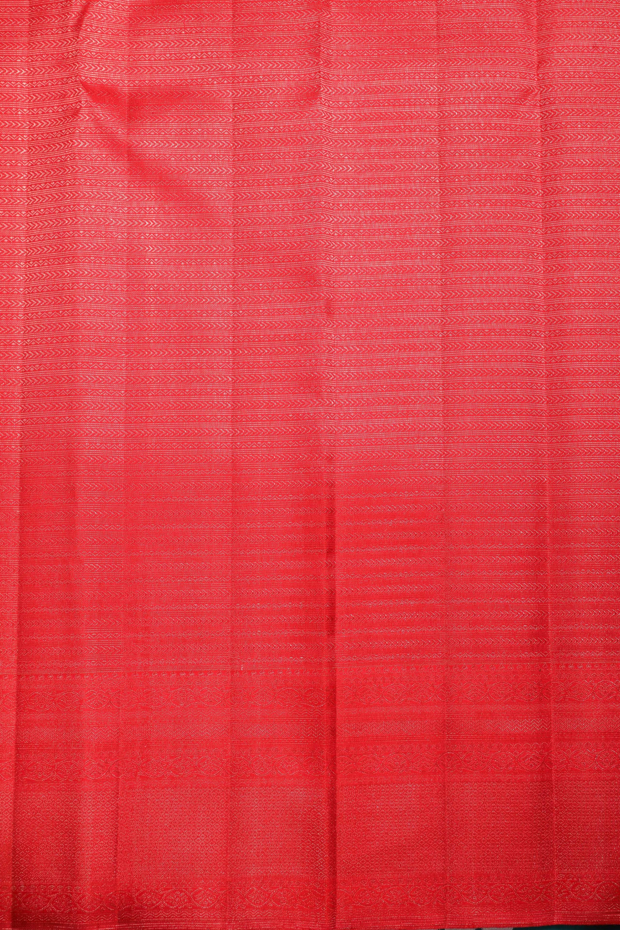 Red Kanchipuram silk saree with intricate zari patterns, perfect for bridal and festive occasions.