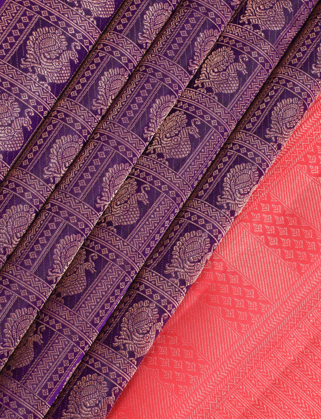 Purple and red Kanchipuram silk sarees with intricate zari patterns and traditional designs